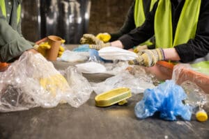 recyclers sorting through plastics at facility